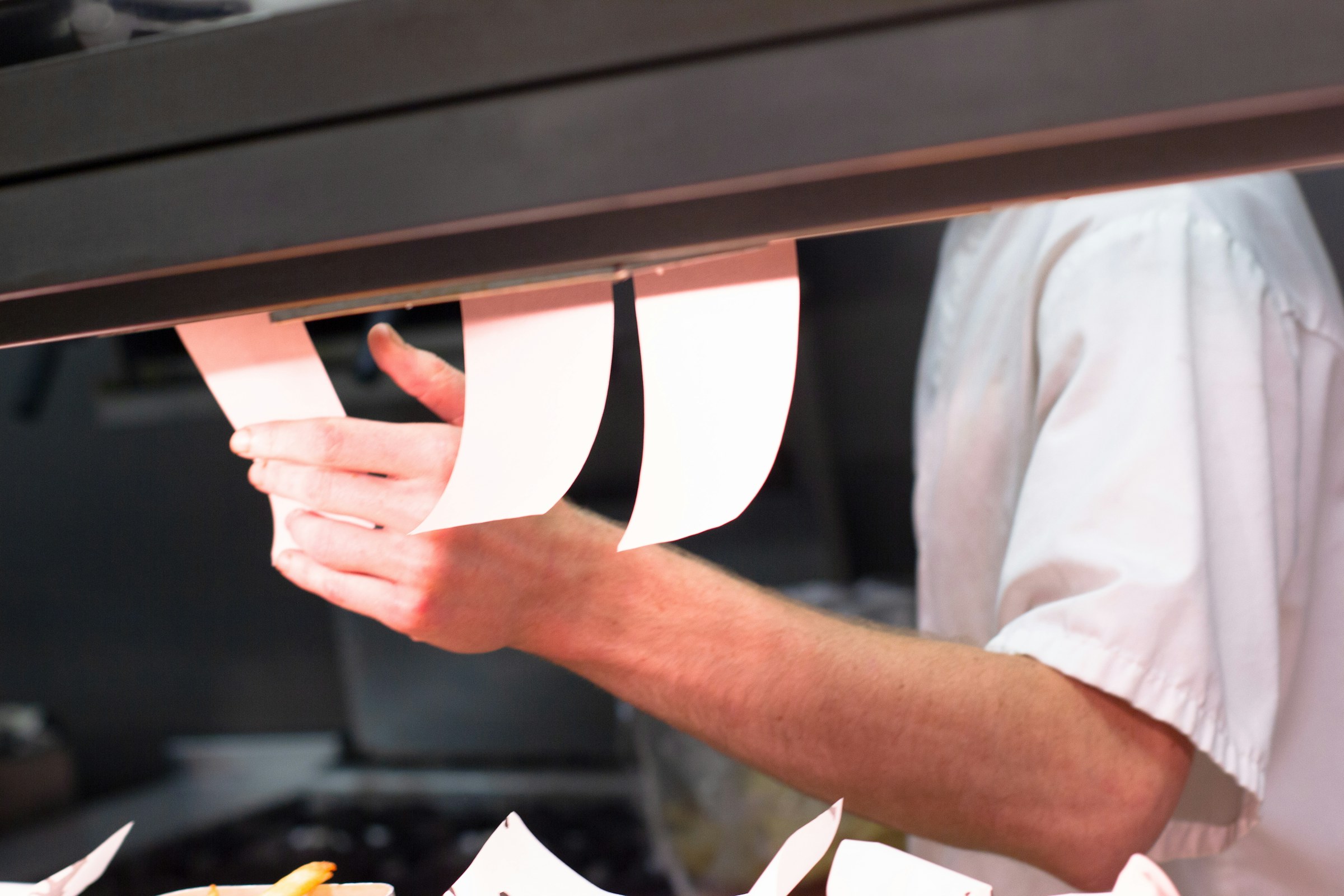 Chef and manager reviewing a printed menu